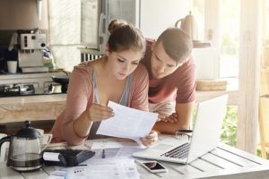 Couple reviewing their money management information.