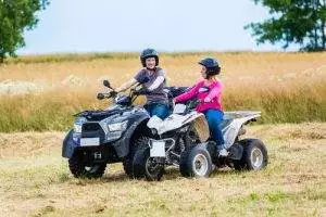 Couple cruising around on their ATV recreational vehicle toys.