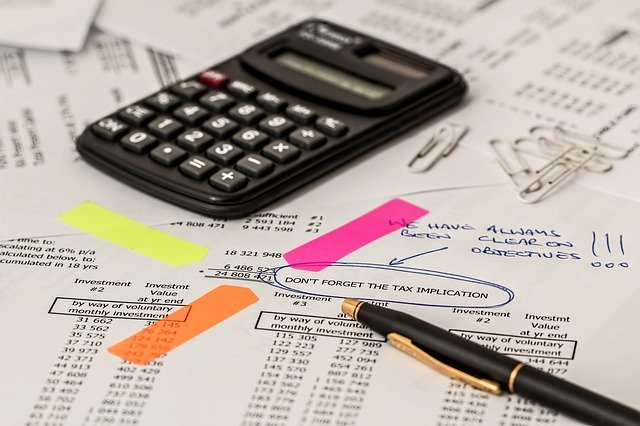 Figuring out your investment strategy with calculator and financial papers.