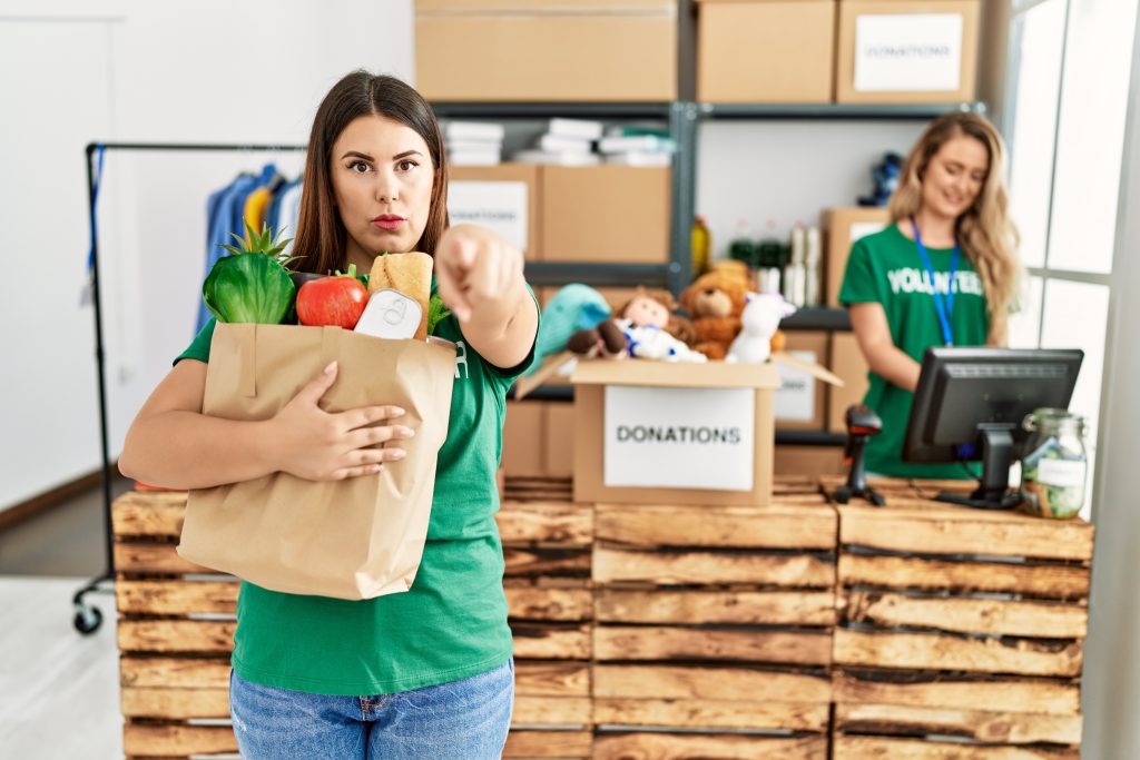 Volunteer pointing at you to consider giving - and consider the charitable tax donation benefits that come with it.