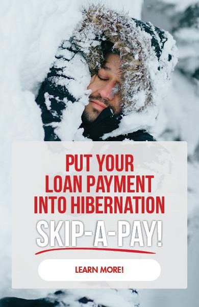 Put your loan payment into hibernation with Skip-A-Pay. Image of a man hibernating in a snow drift.
