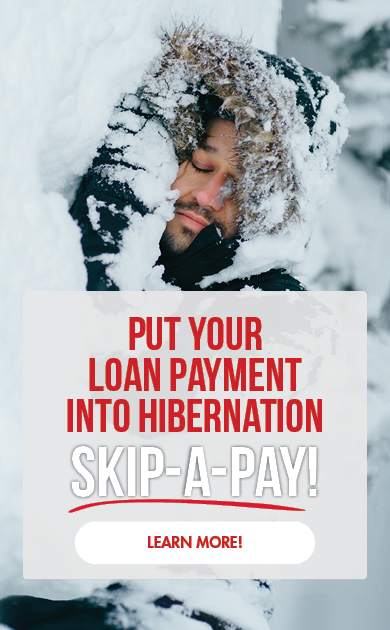 Put your loan payment into hibernation with Skip-A-Pay. Image of a man hibernating in a snow drift.
