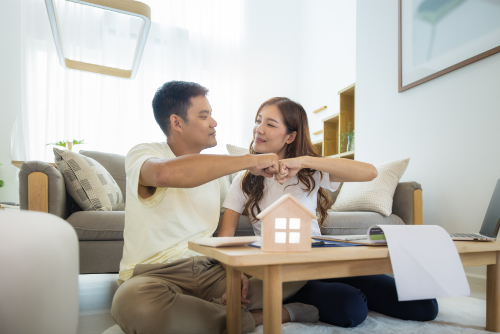 Is this a good time to buy a house? Couple celebrating the purchase of their new home.