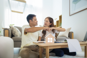 Is this a good time to buy a house? Couple celebrating the purchase of their new home.