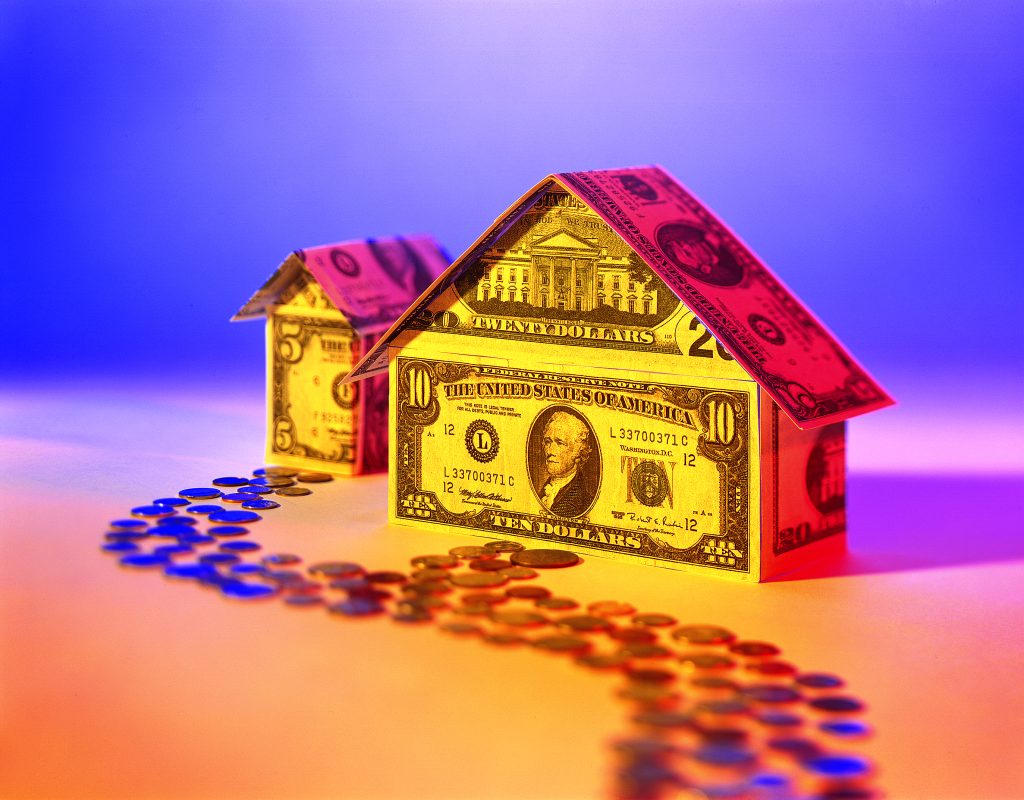 What can a home equity loan be used for? Image of a home made out of money with a coin road.